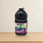 Jugo Natures Own envase de Plastico  1.89 Lts. 64 oz. — ambientación en estudio claro